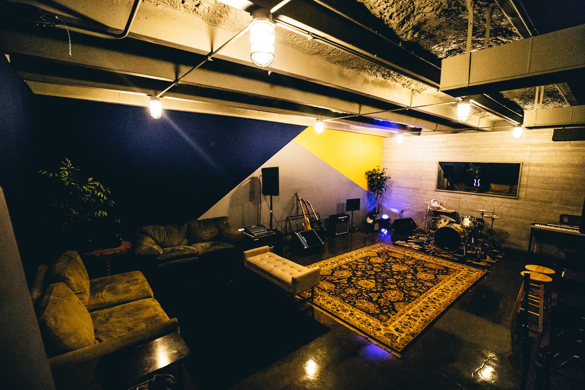 Studio B from above with instruments, rug, and cozy lighting